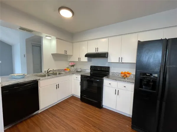 a kitchen with stainless steel appliances a sink stove and refrigerator