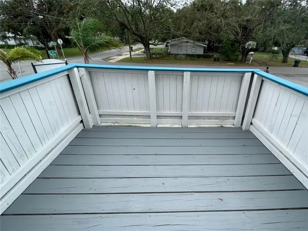 a view of balcony with wooden floor and fence