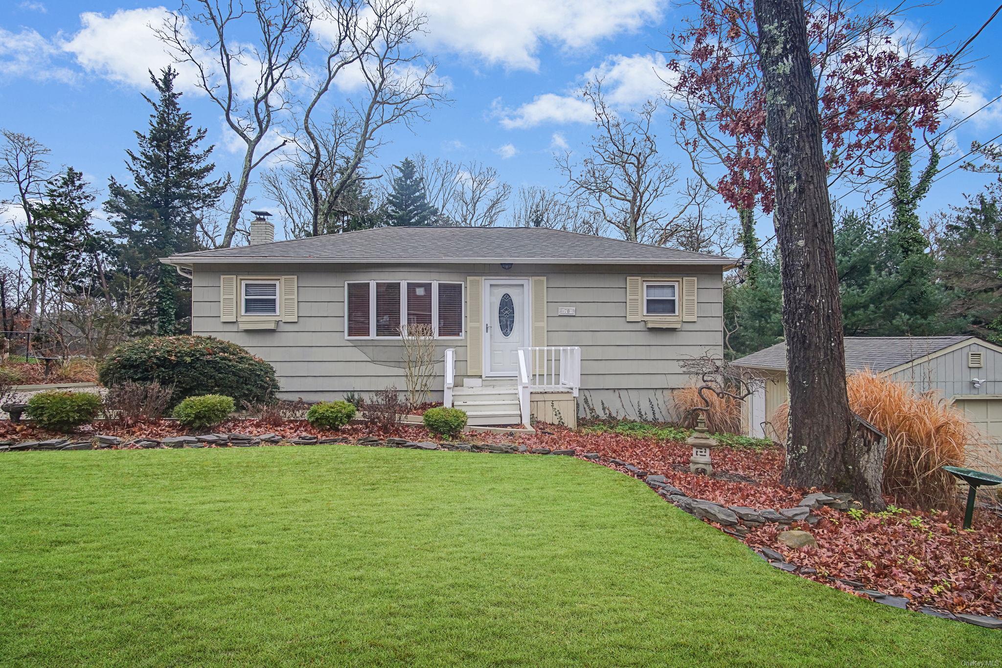 70 Raimond Street Yaphank, NY 11980 - Photo 1 of 1 View of front of property featuring a garage and a front lawn