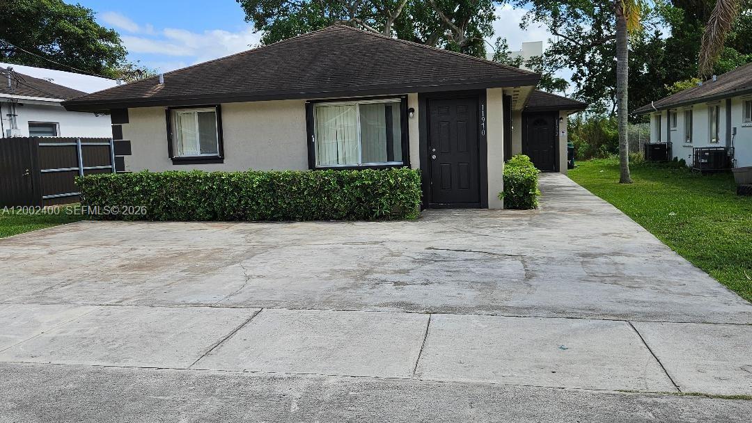 11970 Southwest 217th Street, Unit 11970 Miami, FL 33170 - Photo 13 of 13 a front view of house with yard and trees