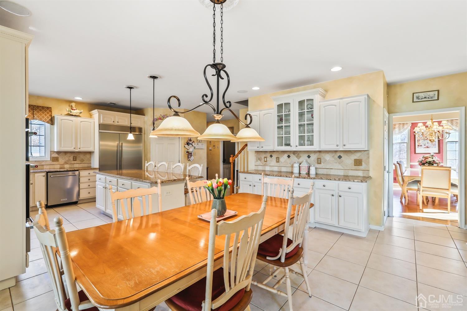 102 Bennett Road Old Bridge, NJ 07747 - Photo 16 of 33 a dining table chairs and a kitchen view