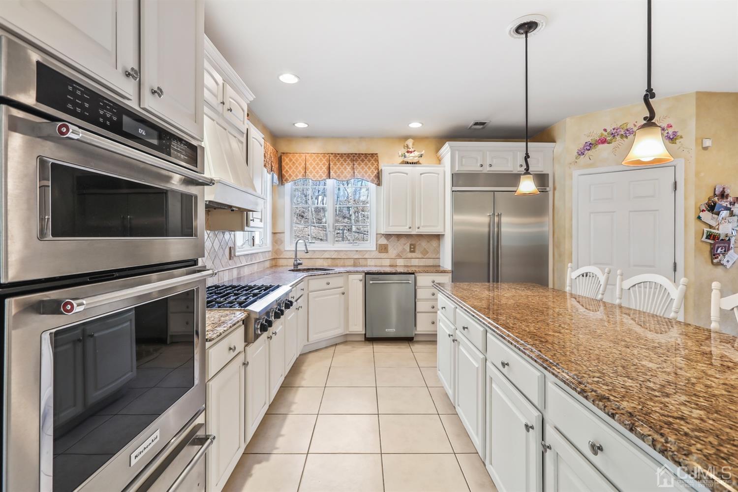 102 Bennett Road Old Bridge, NJ 07747 - Photo 17 of 33 a large kitchen with stainless steel appliances granite countertop a stove a sink and a refrigerator