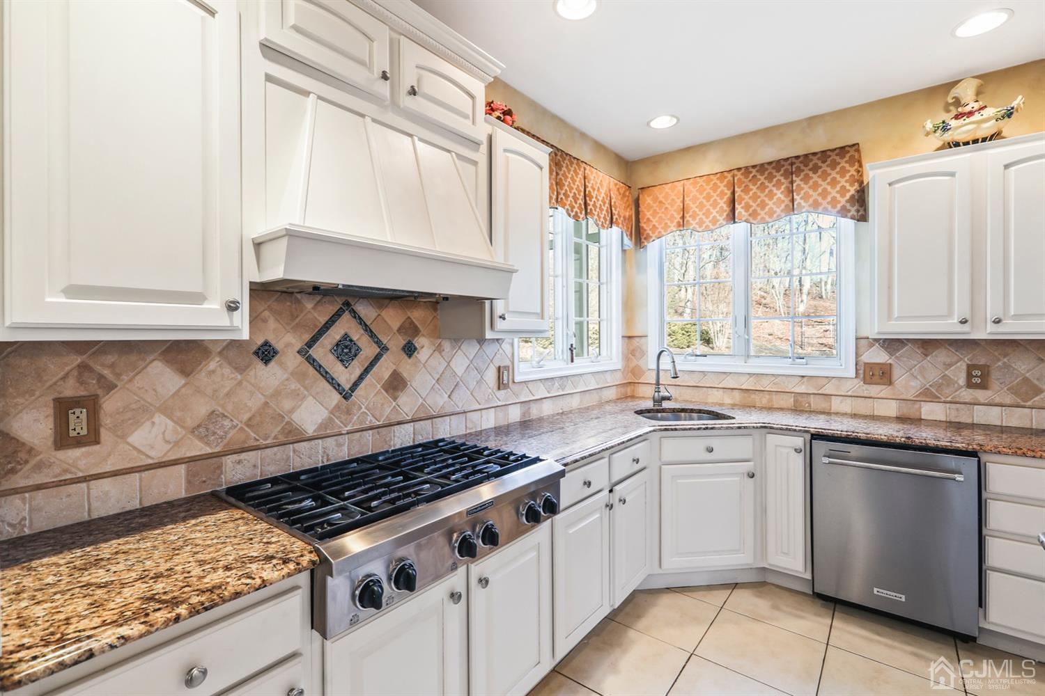 102 Bennett Road Old Bridge, NJ 07747 - Photo 20 of 33 a kitchen with white cabinets and appliances