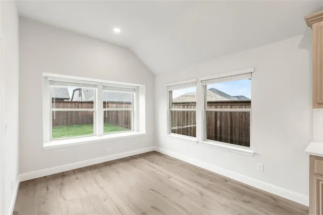 a open kitchen with white cabinets and stainless steel appliances