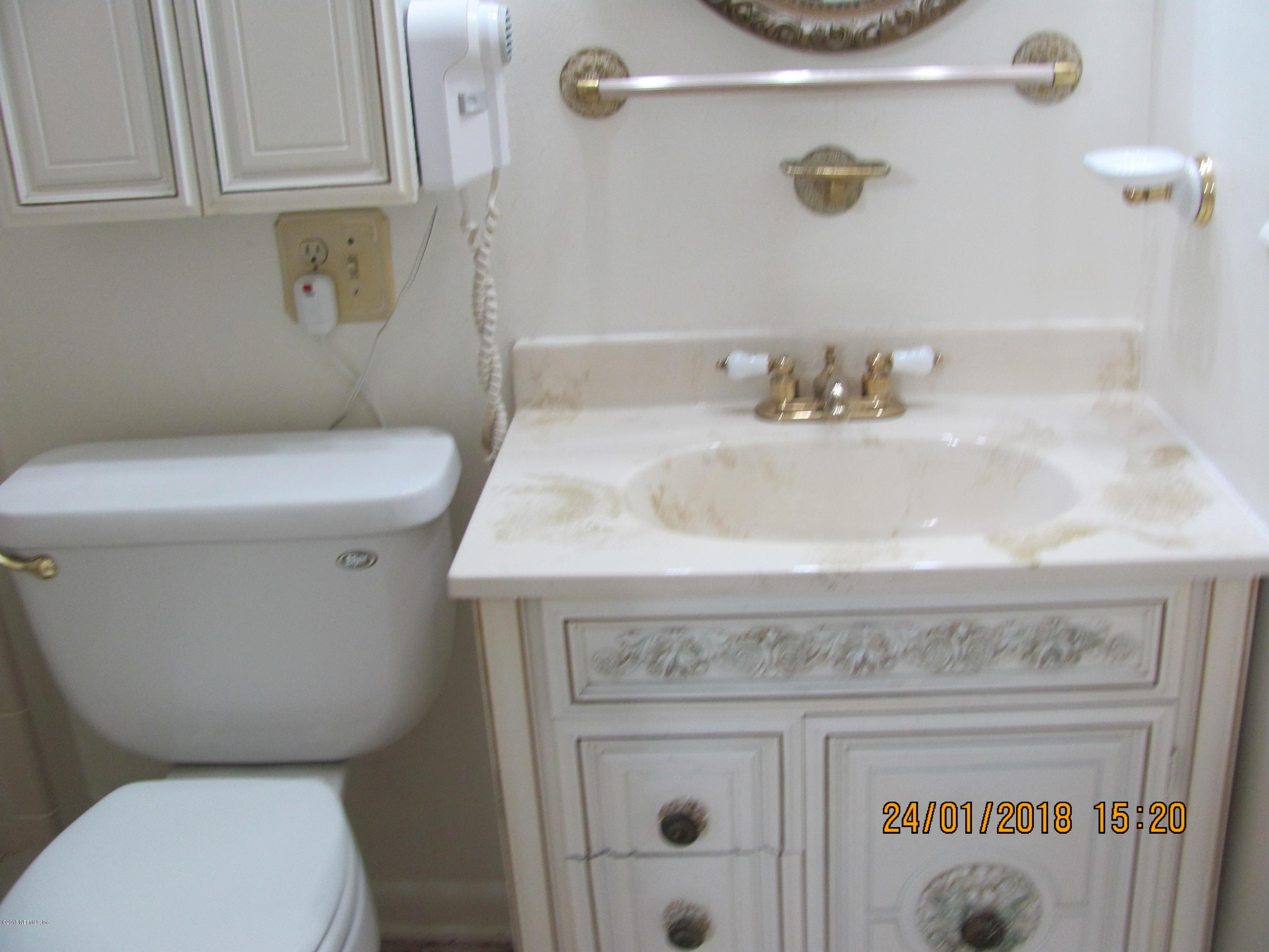 417 Sigsbee Road Orange Park, FL 32073 - Photo 11 of 21 a bathroom with a sink a toilet and a mirror