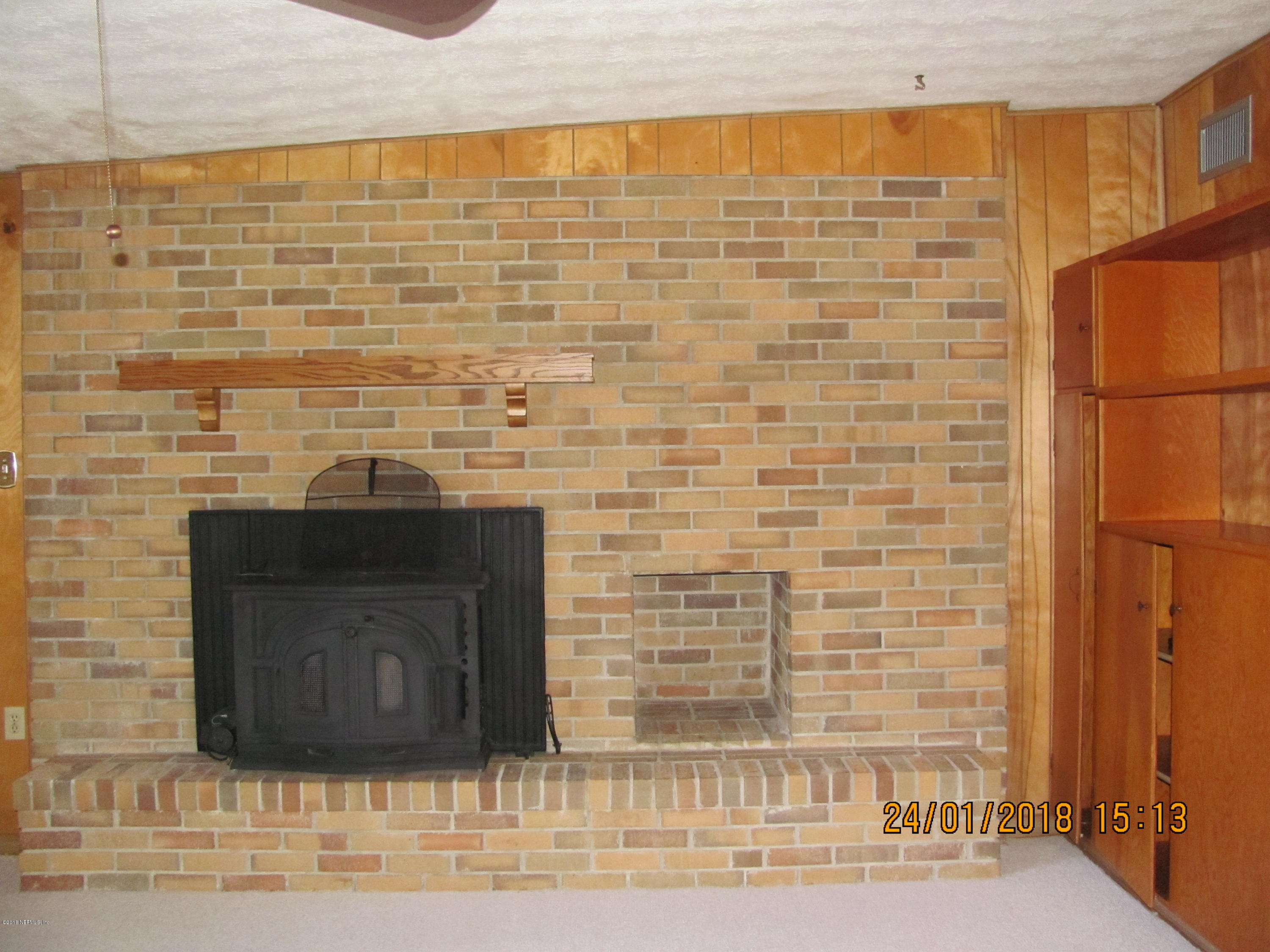 417 Sigsbee Road Orange Park, FL 32073 - Photo 7 of 21 a stone house with a fireplace