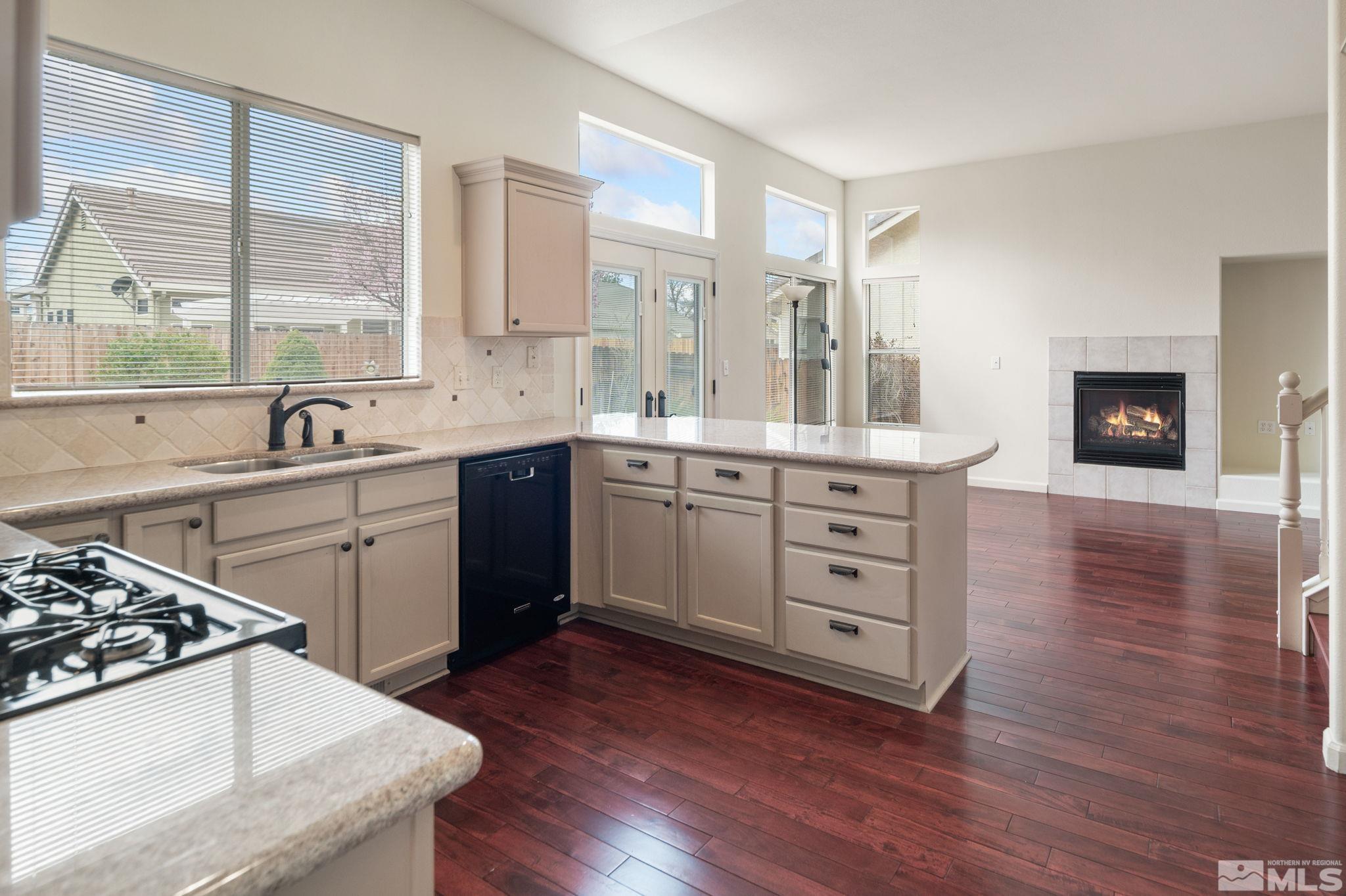 9635 Oakley Lane Reno, NV 89521 - Photo 12 of 40 a kitchen with a stove a sink and wooden floor