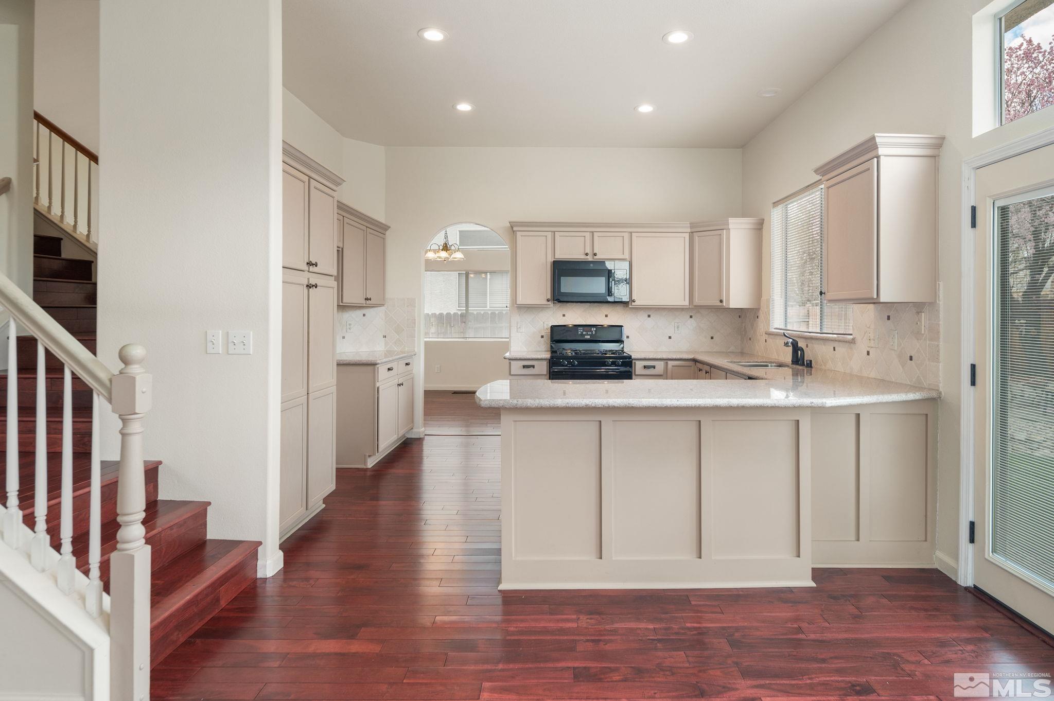 9635 Oakley Lane Reno, NV 89521 - Photo 14 of 40 a open kitchen with white cabinets and stainless steel appliances