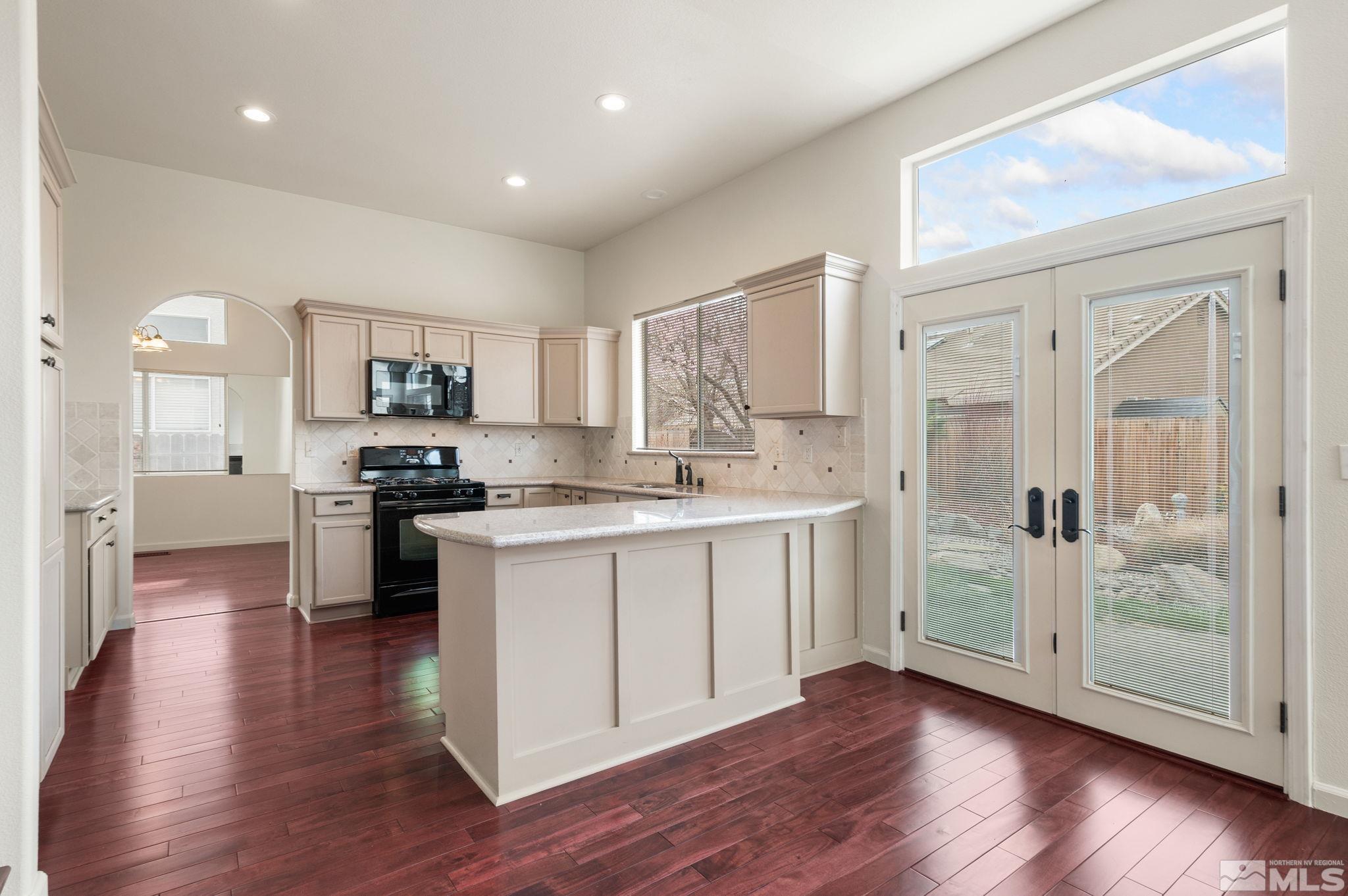 9635 Oakley Lane Reno, NV 89521 - Photo 15 of 40 a kitchen with a refrigerator and a stove top oven
