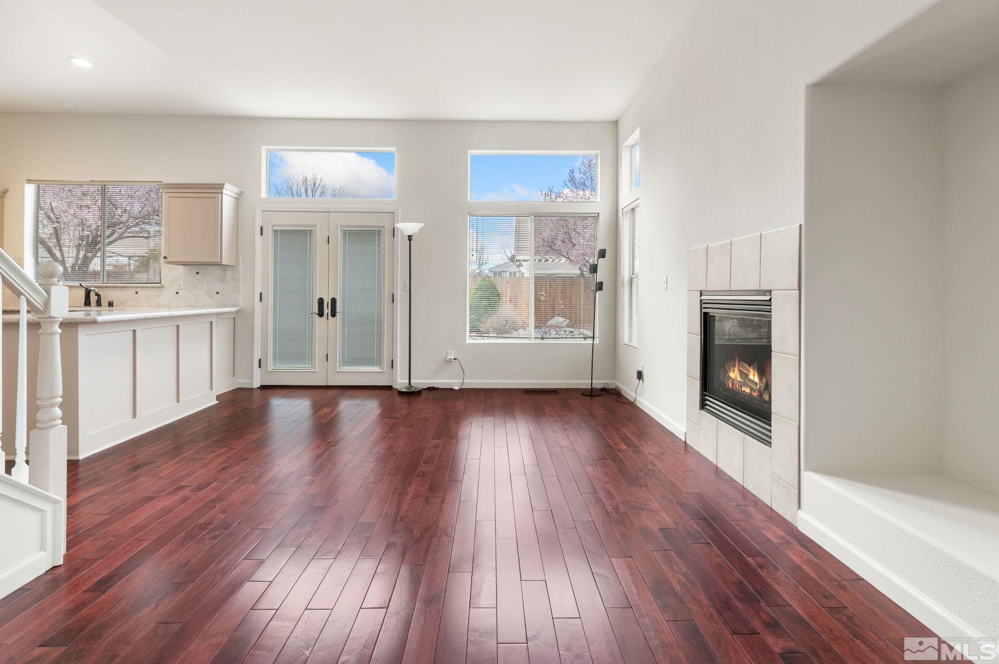 9635 Oakley Lane Reno, NV 89521 - Photo 17 of 40 an empty room with wooden floor and fireplace