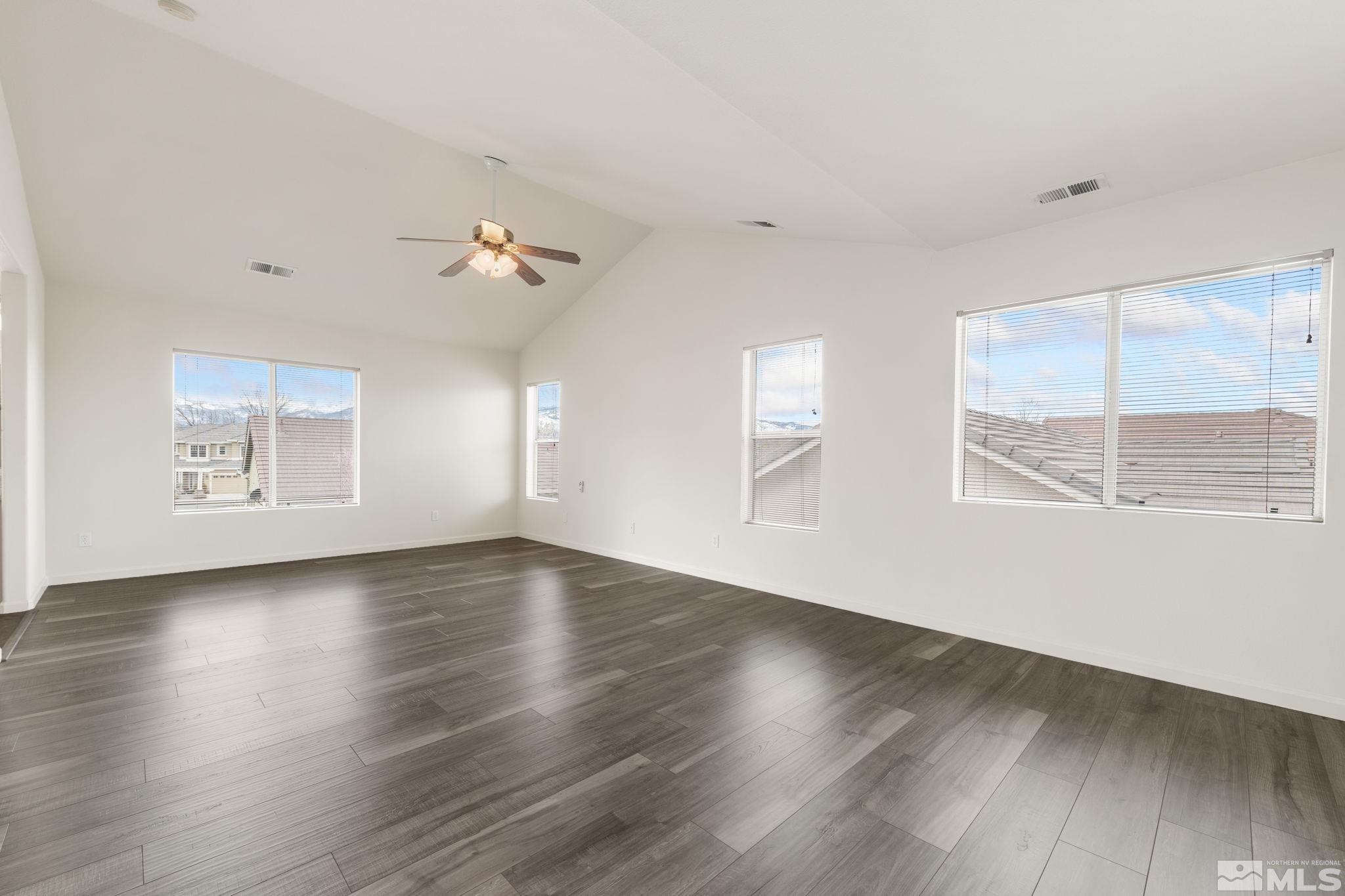 9635 Oakley Lane Reno, NV 89521 - Photo 20 of 40 an empty room with wooden floor and windows