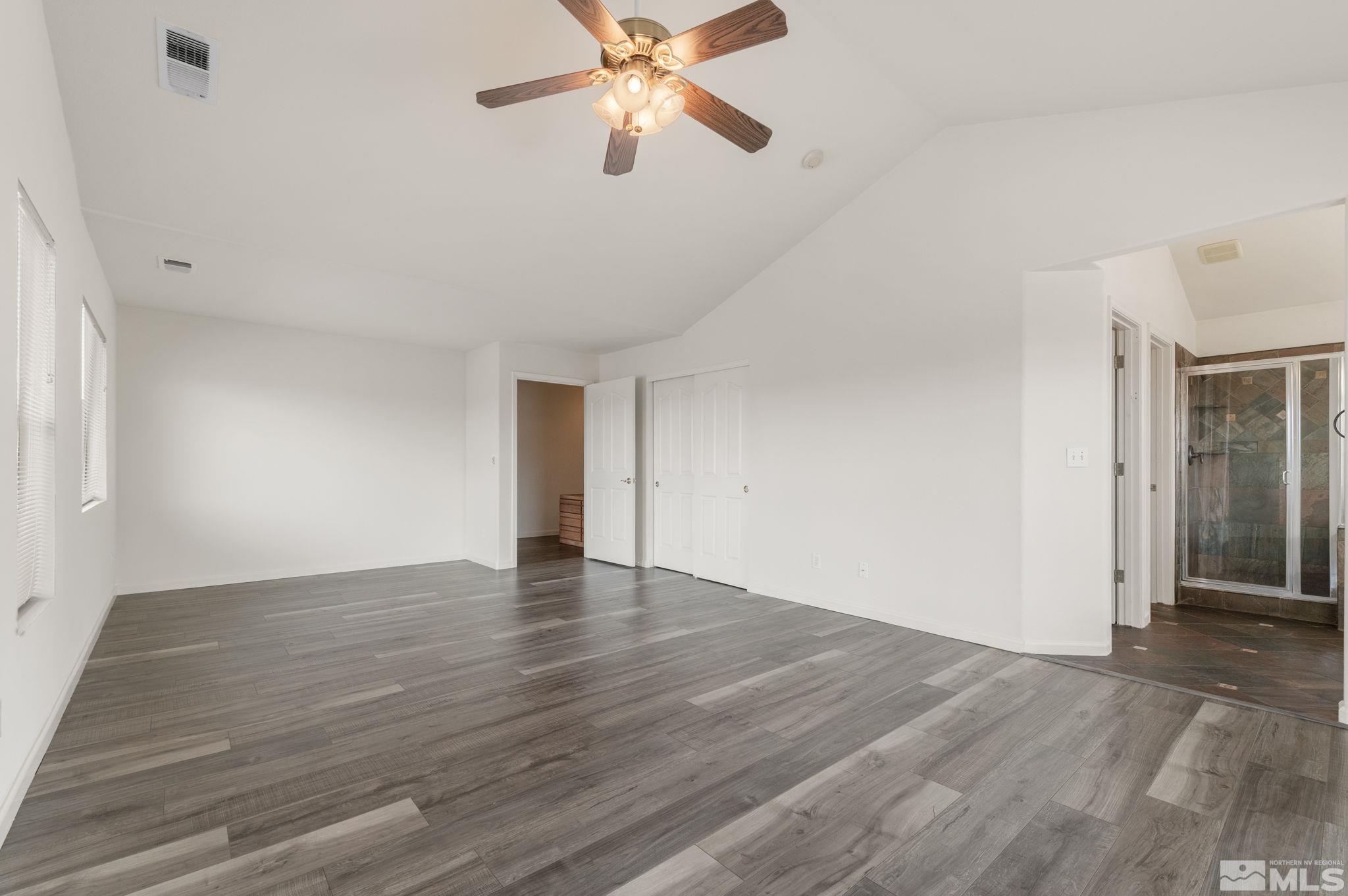 9635 Oakley Lane Reno, NV 89521 - Photo 21 of 40 a view of an empty room with wooden floor and a ceiling fan