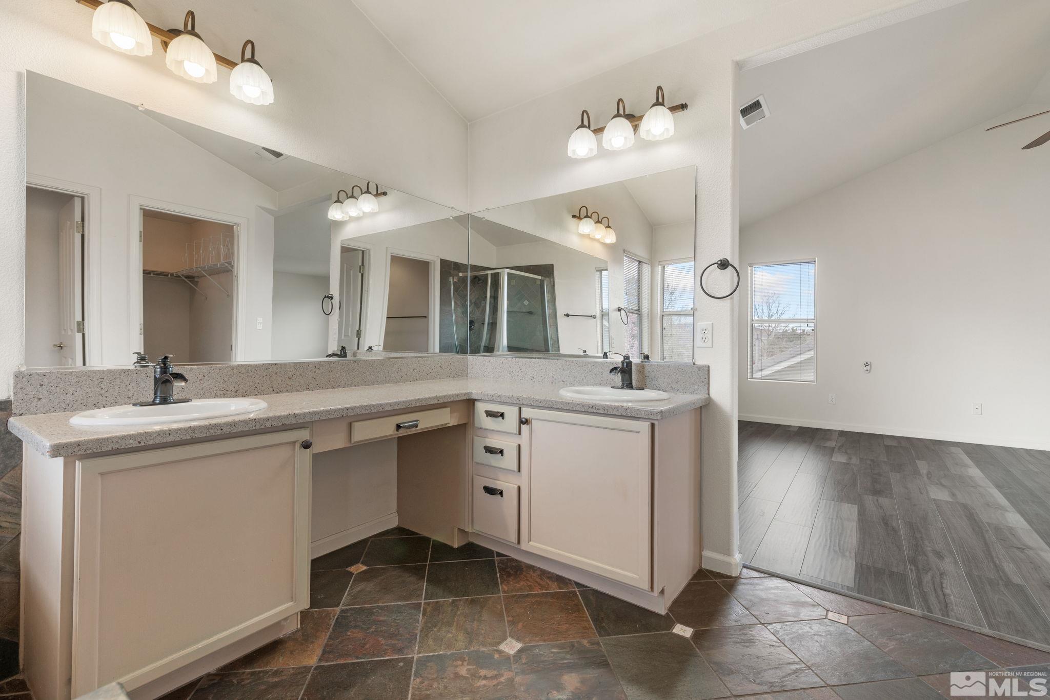9635 Oakley Lane Reno, NV 89521 - Photo 22 of 40 a spacious bathroom with a double vanity sink and a mirror