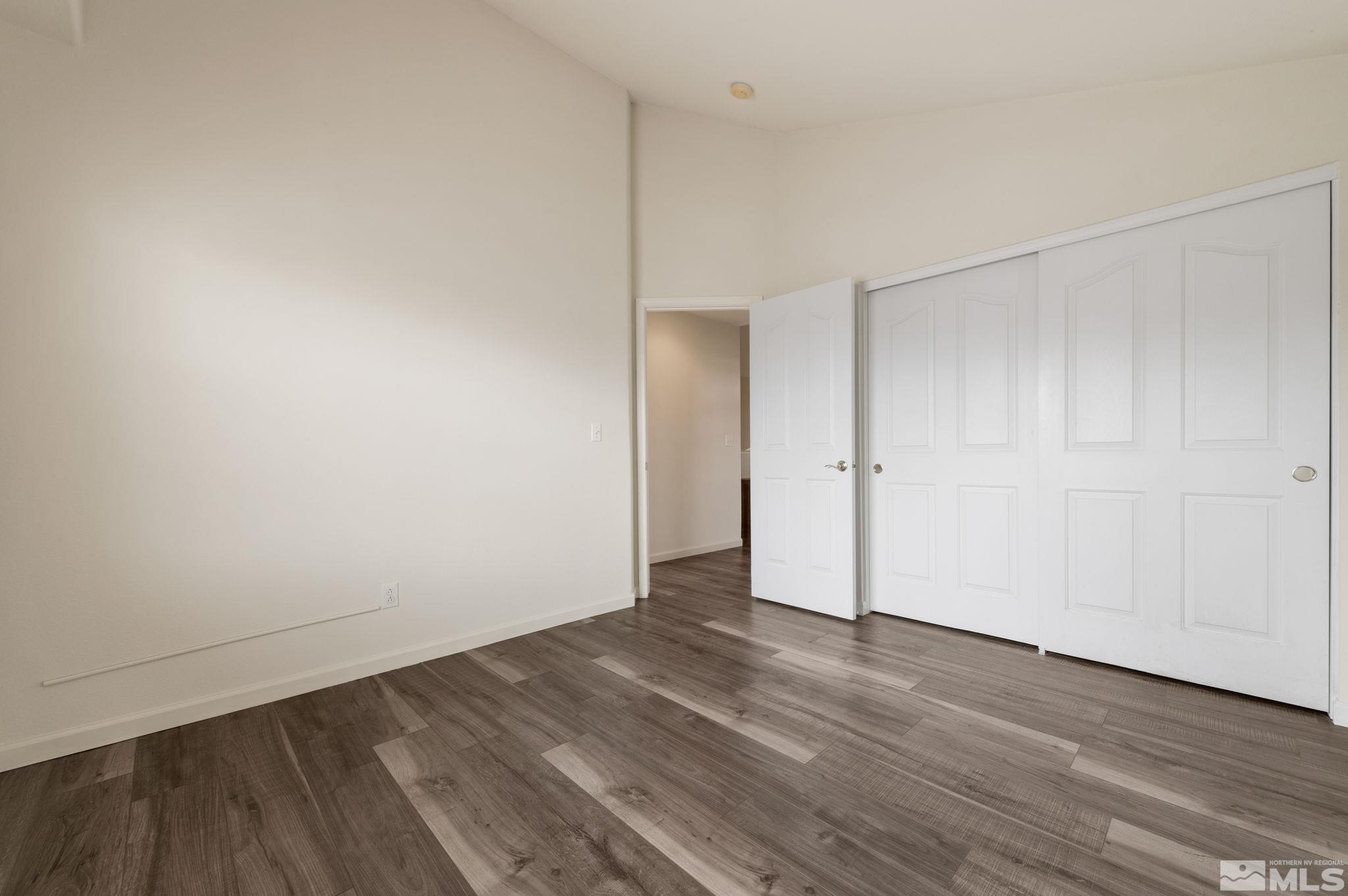 9635 Oakley Lane Reno, NV 89521 - Photo 27 of 40 a view of an empty room with wooden floor
