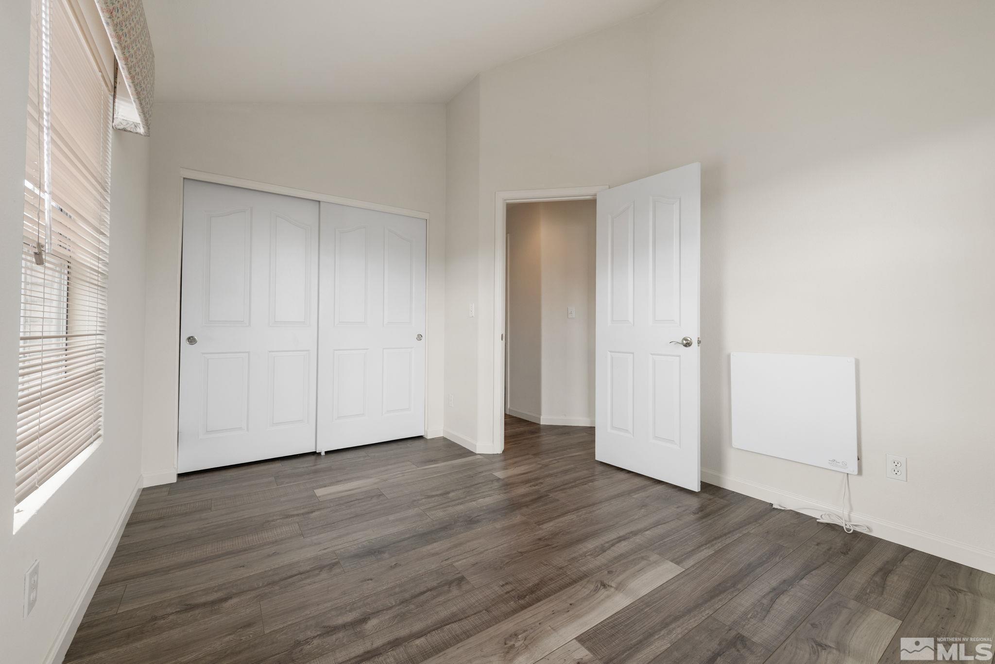 9635 Oakley Lane Reno, NV 89521 - Photo 29 of 40 a view of an empty room with wooden floor and a window