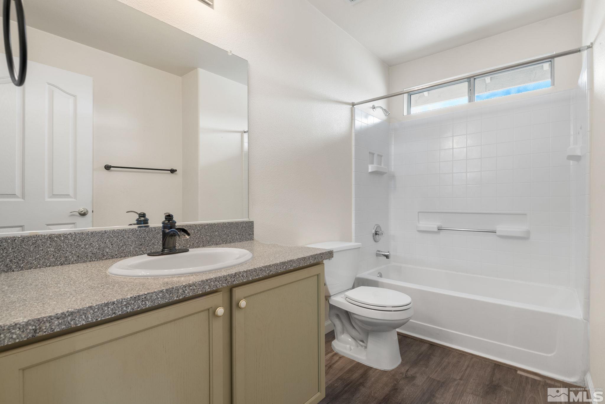 9635 Oakley Lane Reno, NV 89521 - Photo 30 of 40 a bathroom with a granite countertop sink toilet and shower