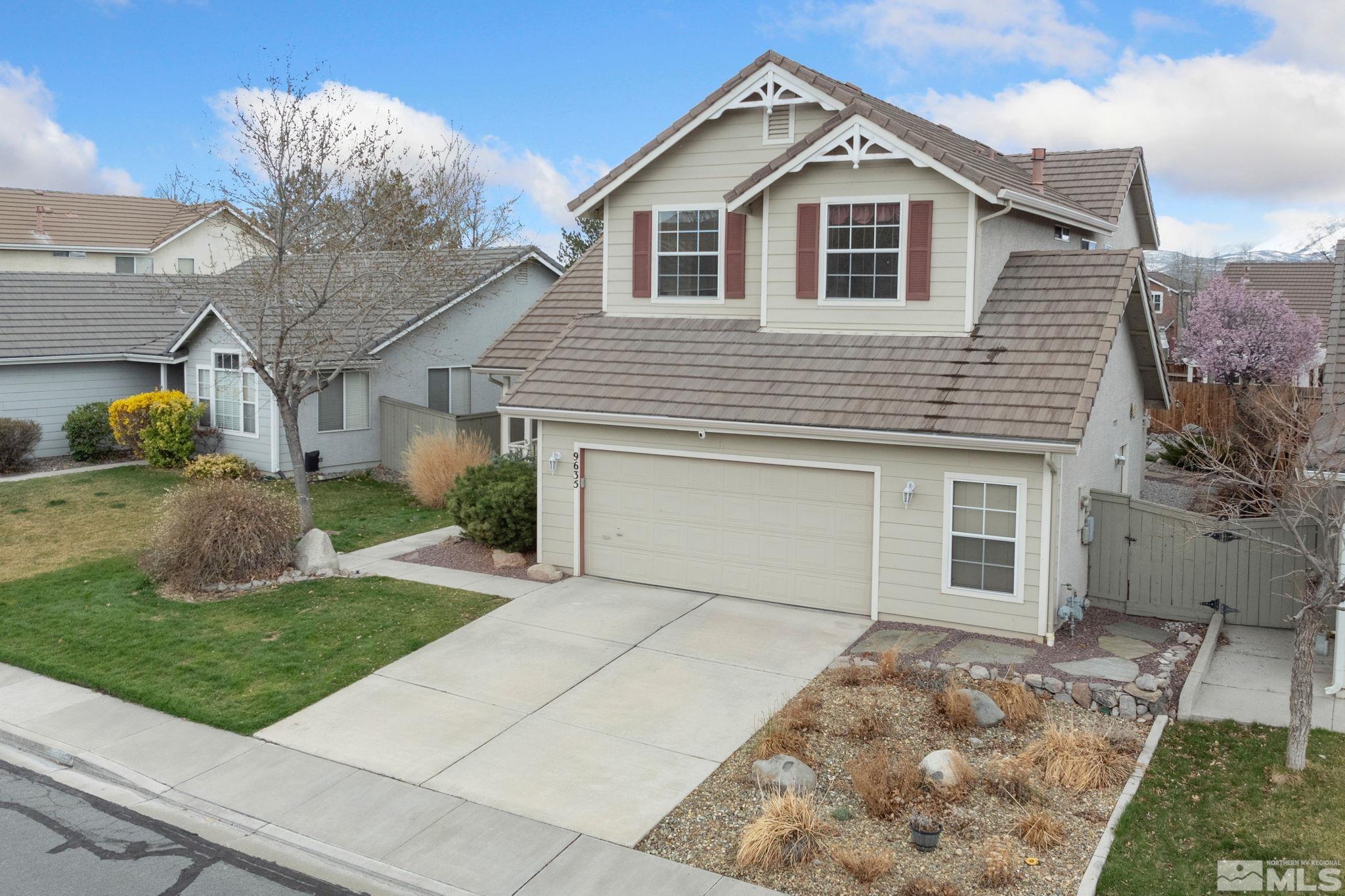 9635 Oakley Lane Reno, NV 89521 - Photo 3 of 40 a front view of a house with a yard and garage