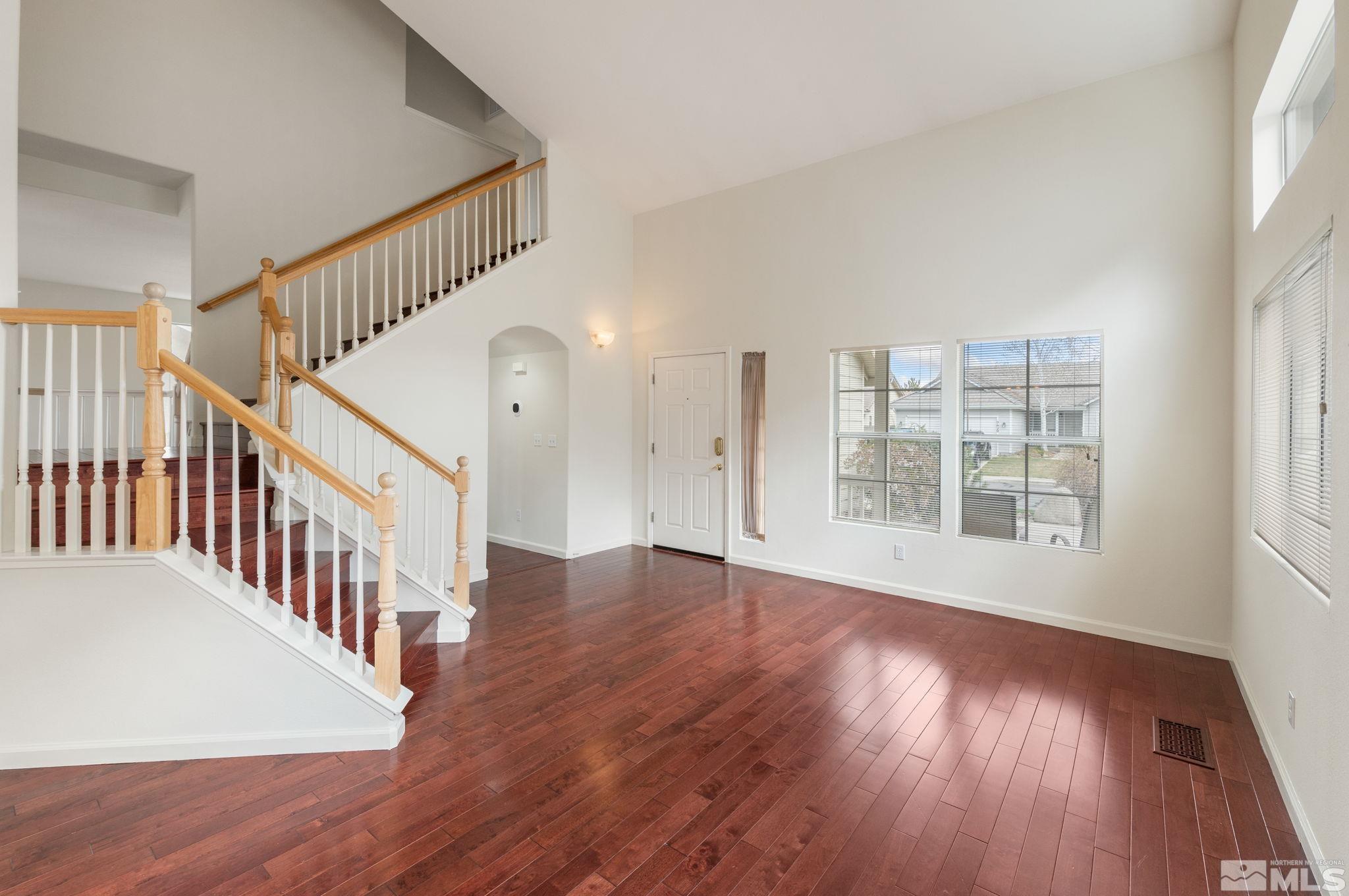 9635 Oakley Lane Reno, NV 89521 - Photo 7 of 40 a view of an empty room with wooden floor and a window