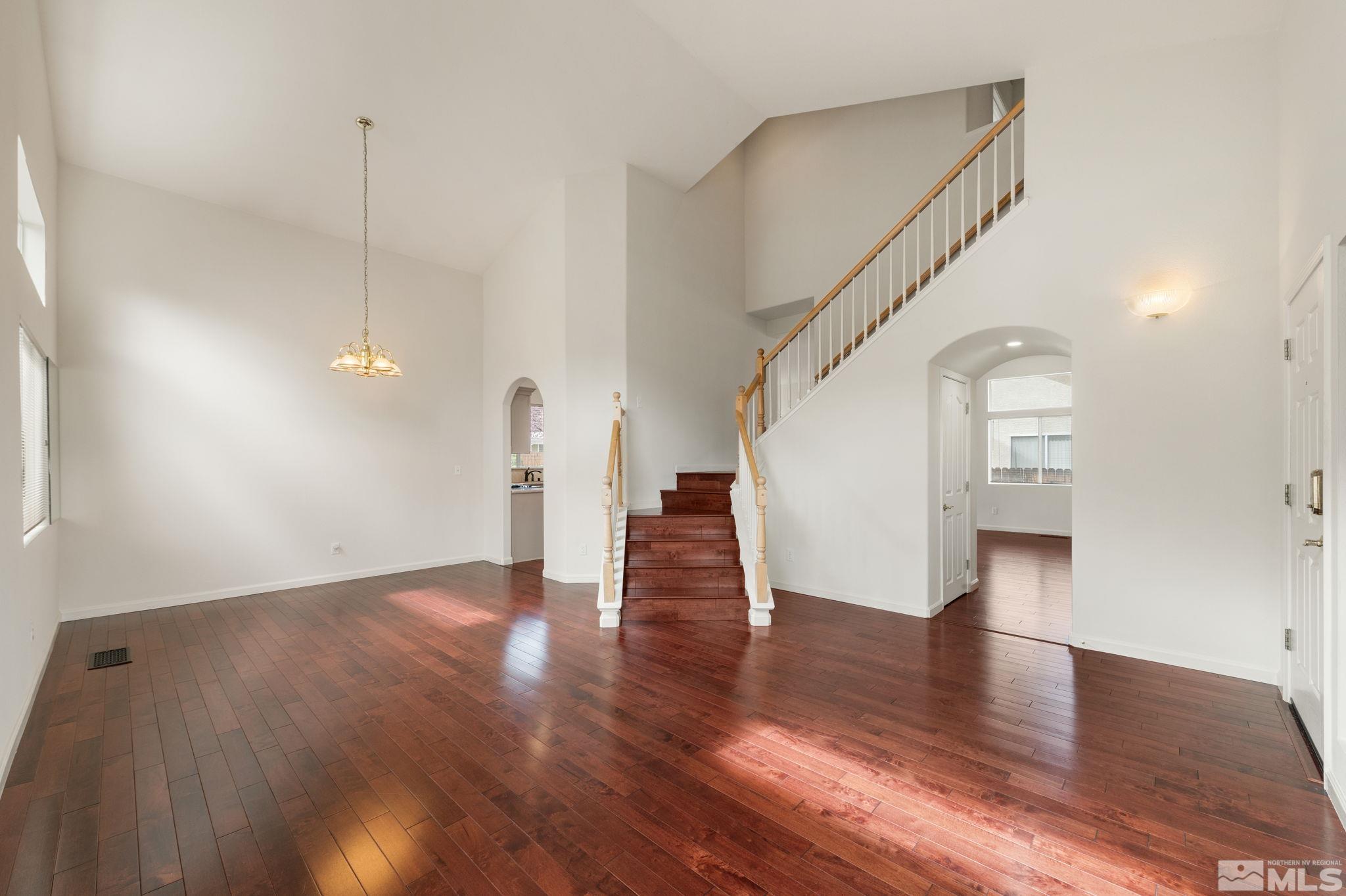 9635 Oakley Lane Reno, NV 89521 - Photo 9 of 40 a view of a hallway with wooden floor and staircase