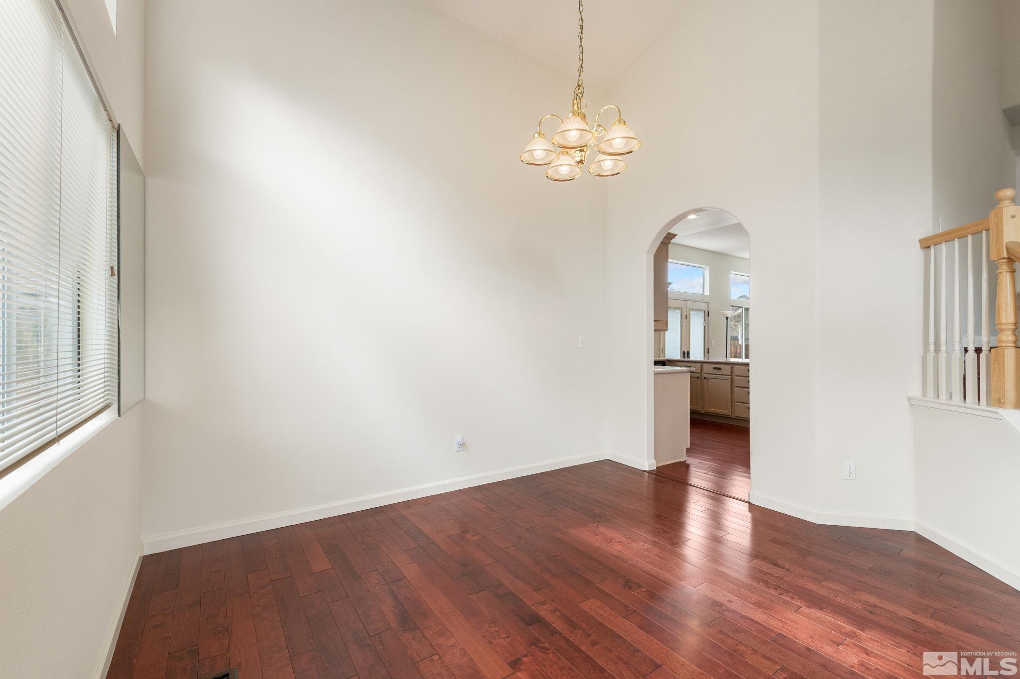 9635 Oakley Lane Reno, NV 89521 - Photo 10 of 40 a view of empty room with wooden floor and stove