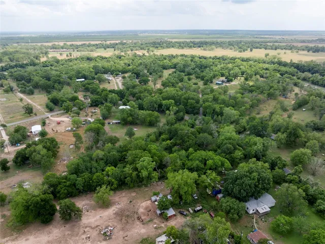 an aerial view of a houses with a yard