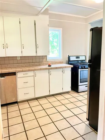 a kitchen with stainless steel appliances a stove sink and cabinets