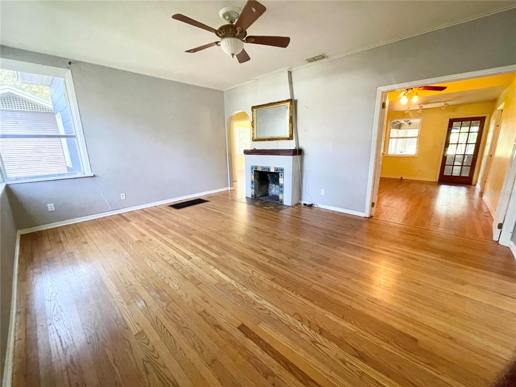915 East Walnut Street Lakeland, FL 33801 - Photo 6 of 27 a view of empty room with wooden floor and fan