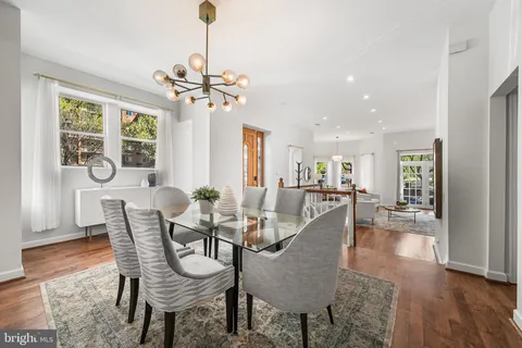 a view of a dining room with furniture wooden floor and a chandelier