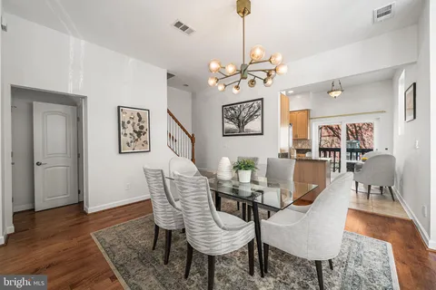 a kitchen with granite countertop a refrigerator sink stove and oven