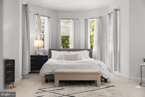 a bedroom with a bed and window