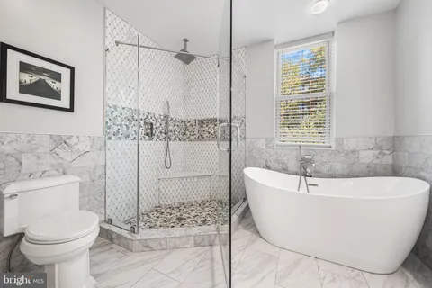 a bathroom with a sink mirror toilet and bathtub