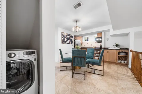 a kitchen with stainless steel appliances granite countertop a refrigerator a stove and a sink