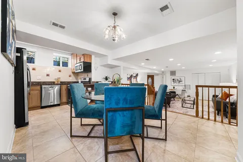 a kitchen with stainless steel appliances granite countertop a stove refrigerator and microwave