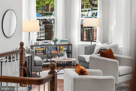 a living room with furniture a rug and a chandelier