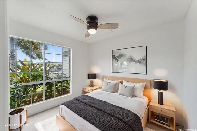 a bedroom with a bed and a large window