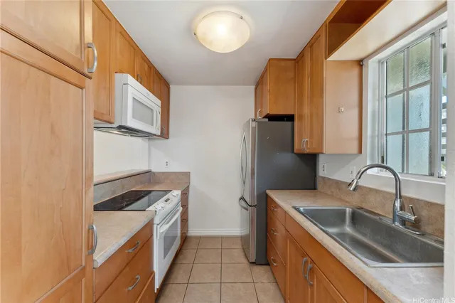 a kitchen that has a sink and a stove in it