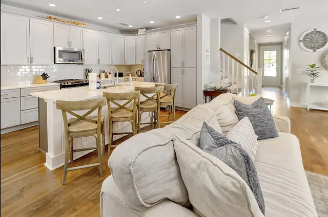 a living room with furniture a window and wooden floor