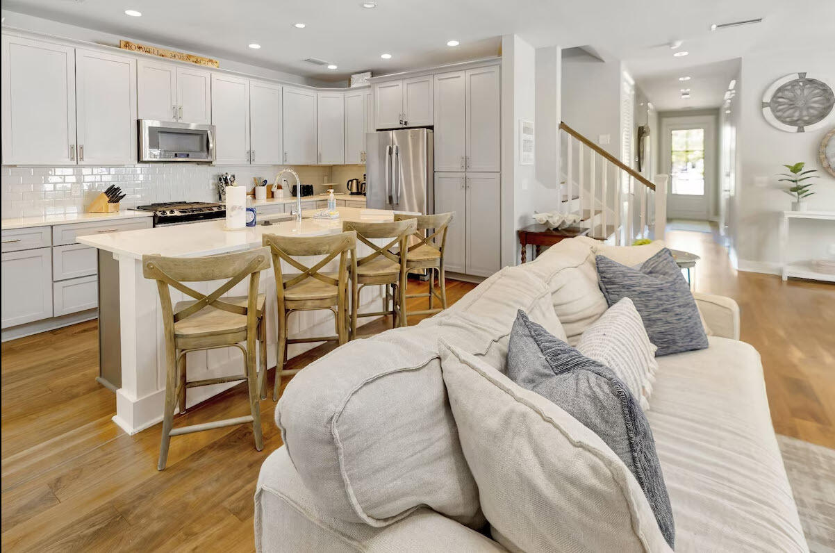 12 Cypress Circle Santa Rosa Beach, FL 32459 - Photo 16 of 33 a kitchen with stainless steel appliances kitchen island granite countertop a table chairs sink and cabinets