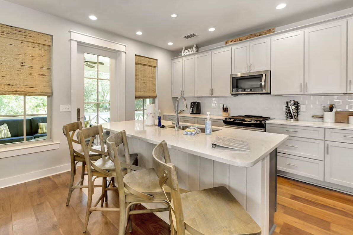 12 Cypress Circle Santa Rosa Beach, FL 32459 - Photo 24 of 33 a kitchen with stainless steel appliances kitchen island granite countertop a sink a stove a refrigerator cabinets and chairs