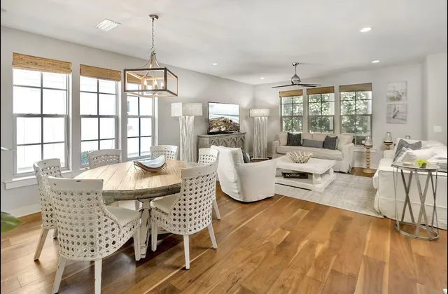 a living room with furniture kitchen view and a chandelier