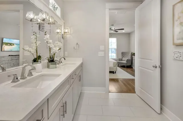 a bathroom with a double vanity sink mirror and shower