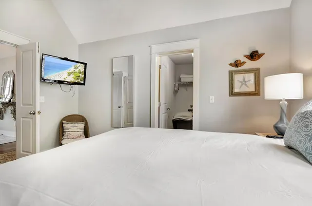a bedroom with a bed and a tv