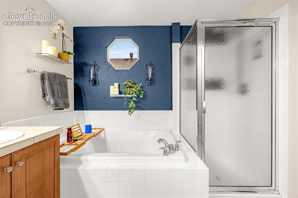 9127 Oakmont Road Peyton, CO 80831 - Photo 23 of 49 a bathroom with a bathtub and a sink
