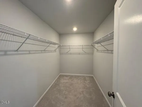 a spacious bathroom with a double vanity sink a mirror and a shower
