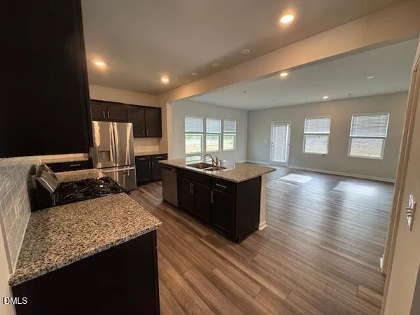 a large room with a lot of counter space and a wooden floor
