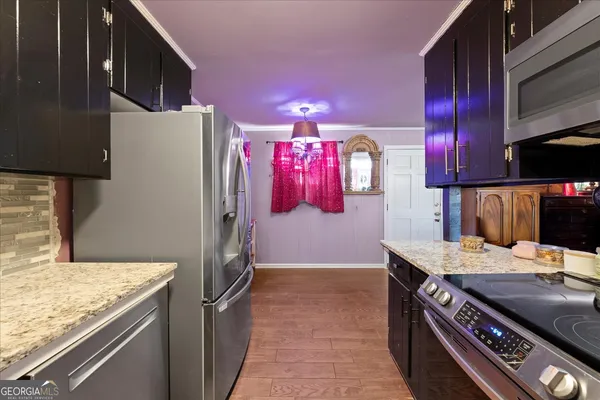 a kitchen that has a stove and a microwave