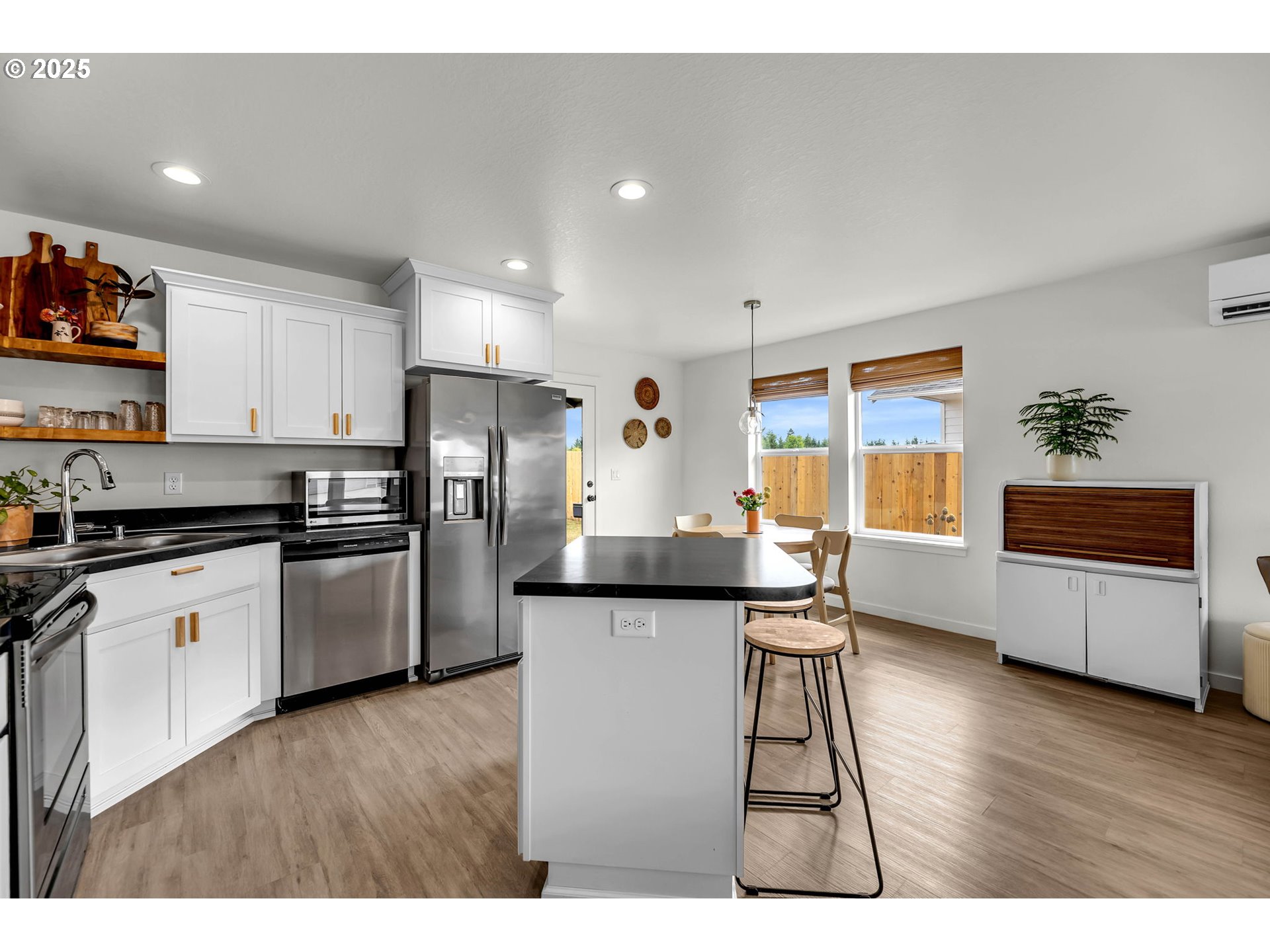 502 Cardinal Avenue Winlock, WA 98596 - Photo 11 of 33 a kitchen with granite countertop wooden floors and white cabinets