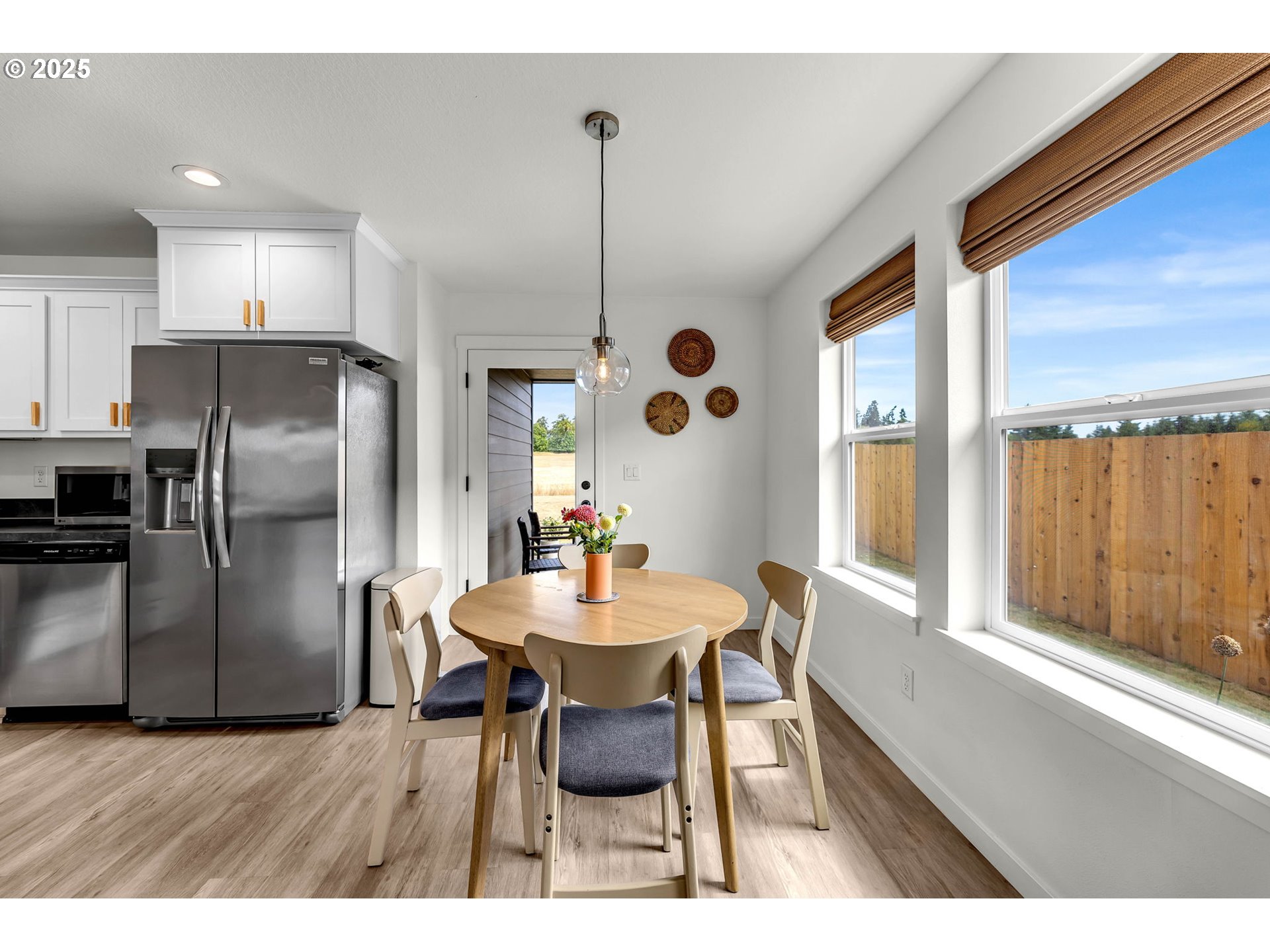 502 Cardinal Avenue Winlock, WA 98596 - Photo 13 of 33 a kitchen with stainless steel appliances kitchen island granite countertop a dining table chairs and a refrigerator