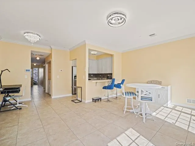 a view of kitchen with furniture and refrigerator