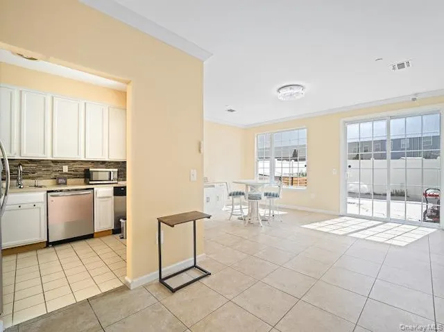 a living room with furniture a dining table and a window